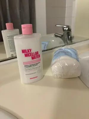 a bottle of mulix mineral water sitting on a bathroom sink at L&L Residence in Brussels