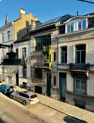 a row of buildings on a city street with a car at L&L Residence in Brussels