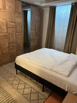 a bedroom with a bed in a room with a window at L&L Residence in Brussels
