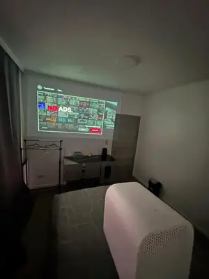 a room with a bed and a projection screen at Sweetroom in Brussels