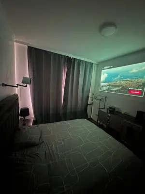 a bedroom with a bed and a large window at Sweetroom in Brussels