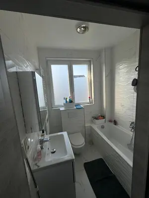 a bathroom with a tub and a toilet and a sink at Sweetroom in Brussels