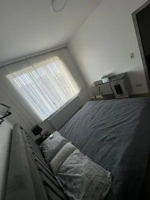 a bedroom with a bed and a large window at Sweetroom in Brussels