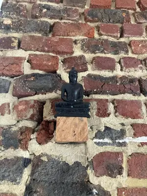 a statue of a person sitting on a brick wall at Nice flat near Brussels in Dilbeek