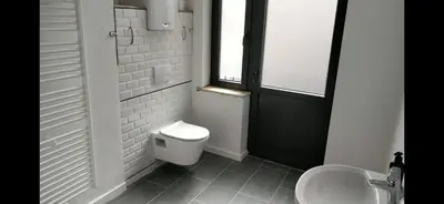 a bathroom with a toilet and a sink and a window at Bruxelles midi flat in Brussels