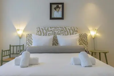 a bedroom with a large white bed with two pillows at SHWAY - The Printing Press in Antwerp