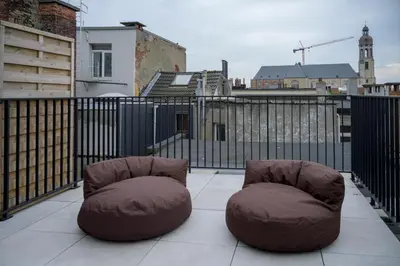 two bean bag chairs sitting on top of a balcony at SHWAY - The Printing Press in Antwerp