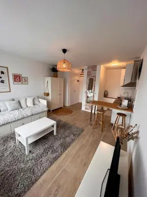 a living room with a couch and a table at Flat moderne et lumineux in Brussels