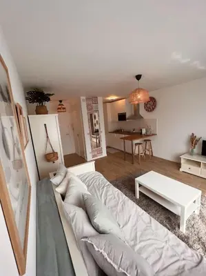 a living room with a couch and a table at Flat moderne et lumineux in Brussels