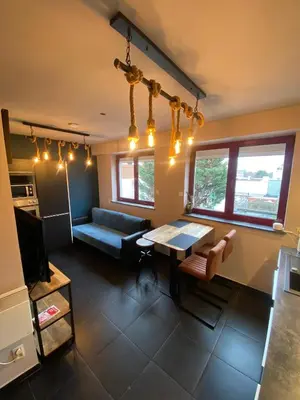 a living room with a couch and a table at J and R Brussels City Apartment in Brussels