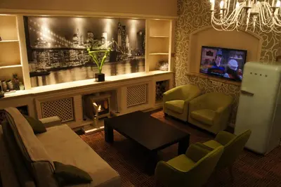 a living room with a fireplace and a tv at J and R Brussels City Apartment in Brussels