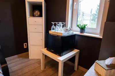 a room with a table and a shelf with glassases on it at B&B De Oude Berg in Mol