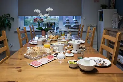 a dining room table with food on top of it at B&B De Oude Berg in Mol