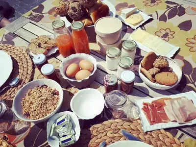 a table with a bunch of breakfast foods on it at B&B De Oude Berg in Mol