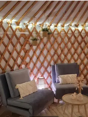 two chairs and a table in a yurt at Yurt 2-4p in Ravels