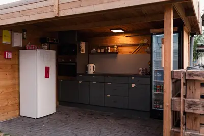 a kitchen with a white refrigerator in a building at Yurt 2-4p in Ravels