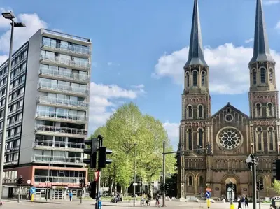 a church with two towers and a building at Central Apartment with City Park View and Terrace in Antwerp