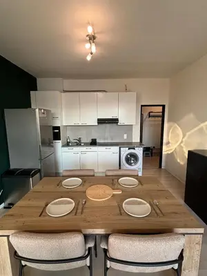a large wooden table in a kitchen with chairs at Central Apartment with City Park View and Terrace in Antwerp