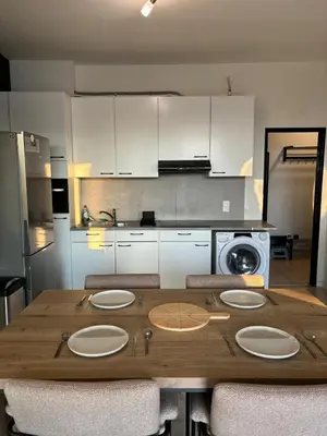 a kitchen with a wooden table with four plates on it at Central Apartment with City Park View and Terrace in Antwerp