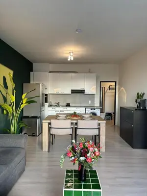 a kitchen and living room with a table and chairs at Central Apartment with City Park View and Terrace in Antwerp