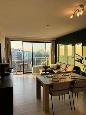 a living room with a couch and a table at Central Apartment with City Park View and Terrace in Antwerp