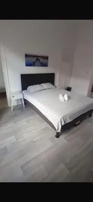 a bedroom with a large bed with a white comforter at Brussels city center apartment in Brussels