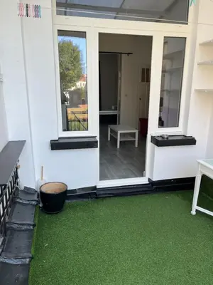 a screened in porch with green grass at Brussels city center apartment in Brussels