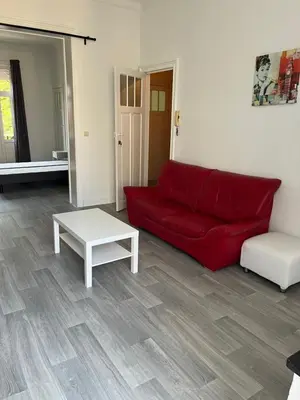 a living room with a red couch and a table at Brussels city center apartment in Brussels