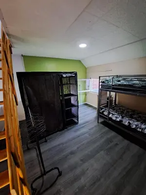 an empty room with two bunk beds in it at Gezellige Rijwoning met tuin in Werkstede