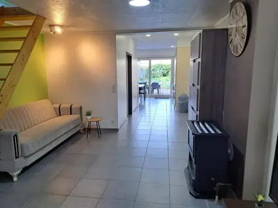 a living room with a couch and a tv at Gezellige Rijwoning met tuin in Werkstede