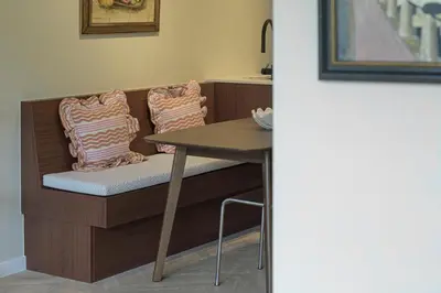 a dining room table and chair with a table and pillows at SHWAY - The Book Binder in Antwerp