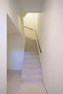 a staircase in a building with a white wall at SHWAY - The Book Binder in Antwerp