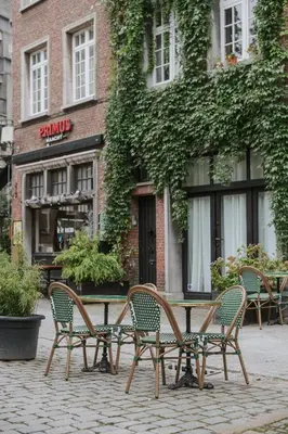 a table and chairs in front of a building at SHWAY - The Book Binder in Antwerp