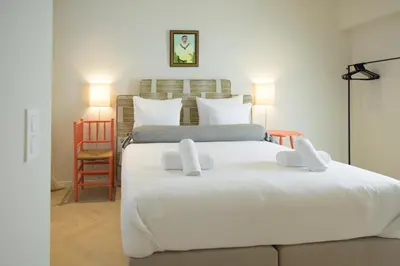 a bedroom with two beds with white sheets at SHWAY - The Book Binder in Antwerp