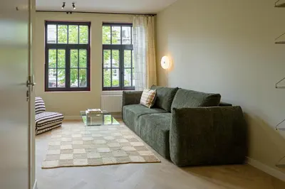 a living room with a couch and a table at SHWAY - The Book Binder in Antwerp