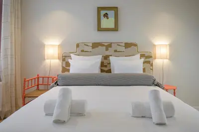 a bedroom with a large white bed with white pillows at SHWAY - The Proof Reader in Antwerp