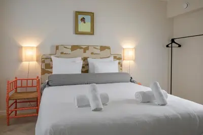 a bedroom with a large white bed with towels on it at SHWAY - The Proof Reader in Antwerp