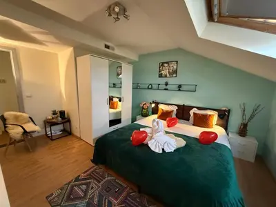 a bedroom with a large green bed with towels on it at Dreamland in Zaventem