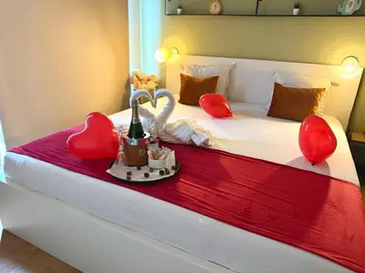a hotel room with a bed with red hearts on it at Dreamland in Zaventem