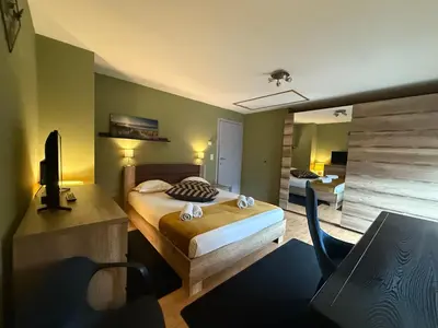 a bedroom with a bed and a desk and a chair at Dreamland in Zaventem