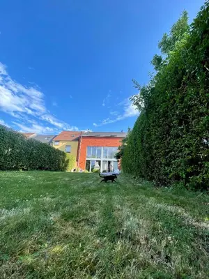 a bench in the grass in front of a building at Dreamland in Zaventem