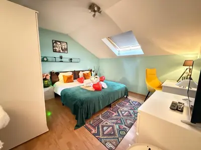 a bedroom with a bed with stuffed animals on it at Dreamland in Zaventem