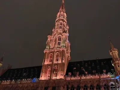 a large building with a clock tower at night at LUX Appartment in BXL Center in Brussels