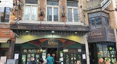 a store on a street with people walking in front of it at LUX Appartment in BXL Center in Brussels