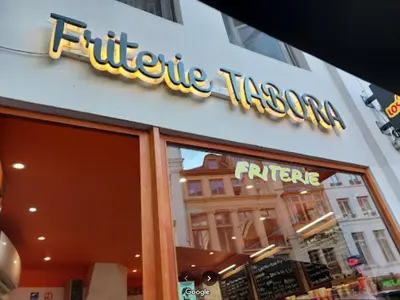 a store sign on the front of a building at LUX Appartment in BXL Center in Brussels