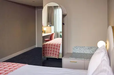 a hotel room with a bed and a mirror at Van der Valk Hotel Park Lane Antwerpen in Antwerp