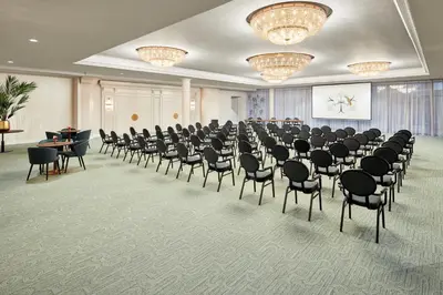 a room with rows of chairs and a screen at Van der Valk Hotel Park Lane Antwerpen in Antwerp