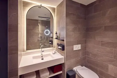 a bathroom with a sink and a toilet at Van der Valk Hotel Park Lane Antwerpen in Antwerp