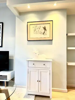 a room with a white cabinet and a picture on the wall at Beautiful 2 bedroom familiar luxury apartment in Brussels