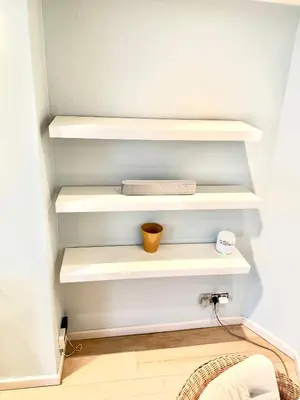 a walk in closet with white shelves at Beautiful 2 bedroom familiar luxury apartment in Brussels